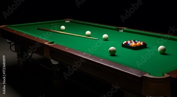 Fototapeta A well-lit shot of a billiards table with balls in a classic arrangement, ready for a game. The table's green felt contrasts with the dark background, emphasizing the game's focus