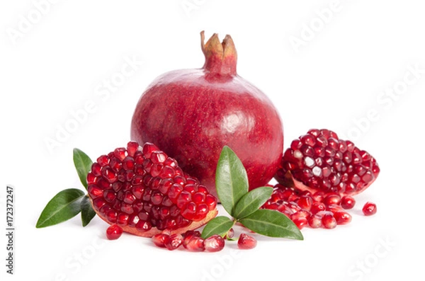 Fototapeta one whole and part of a pomegranate with pomegranate seeds and leaves isolated on white background