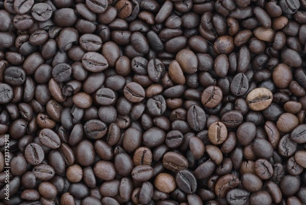Fototapeta Roasted coffee beans background in warm dark scene