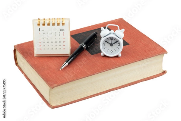 Fototapeta Desk calendar for January 2026 with an alarm clock, pen, and old book. Concept of new year resolutions, planning, scheduling, and time management isolated on white background with clipping path.