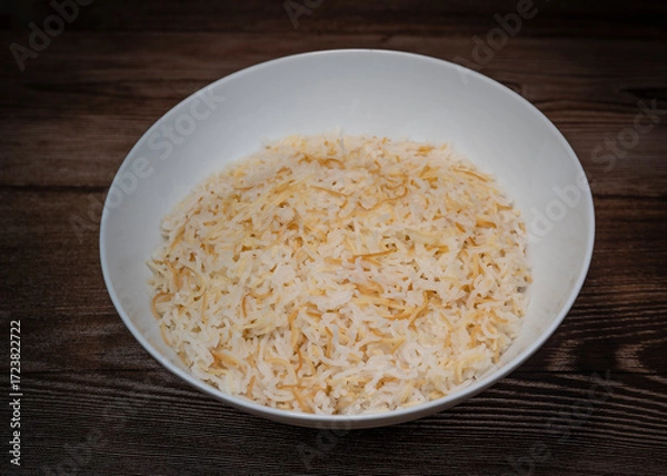 Fototapeta Savor a delightful Lebanese rice dish made with fluffy rice, perfectly cooked vermicelli, and fragrant butter. Ideal as a comforting side complementing main meals