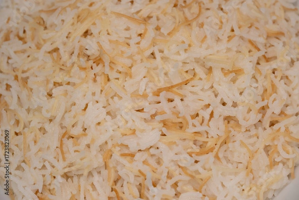 Fototapeta Savor a delightful Lebanese rice dish made with fluffy rice, perfectly cooked vermicelli, and fragrant butter. Ideal as a comforting side complementing main meals