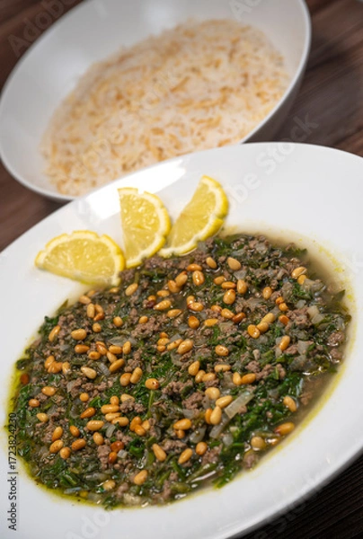 Fototapeta Spinach or Sabanekh with chicken a Mediterranean dish served with rice, Lebanese recipe. High quality photo
