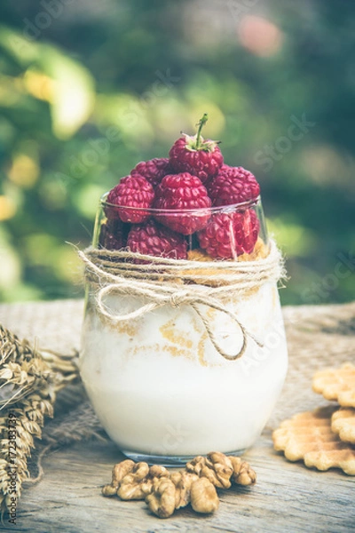 Fototapeta Homemade yogurt with raspberries and cereals. Useful breakfast