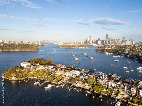 Fototapeta Sydney, Australia: Aerial view of the Birchgrove affluent suburb with the Sydney skyline and harbor bridge in Australia