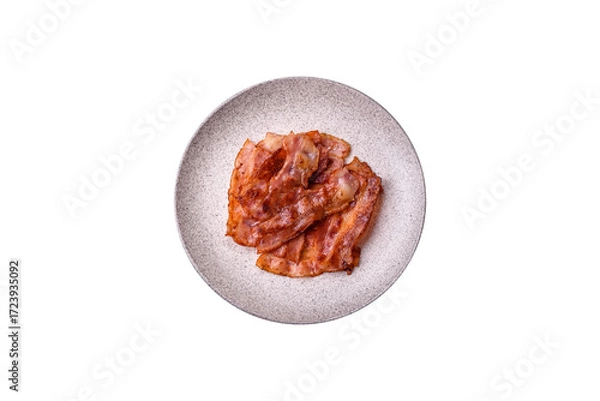 Fototapeta Fried pork bacon slices or strips as a breakfast ingredient. Fried bacon
