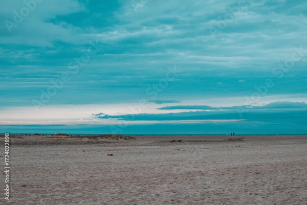 Fototapeta Calm beach landscape at dusk with soft waves and tranquil skies in a serene coastal area
