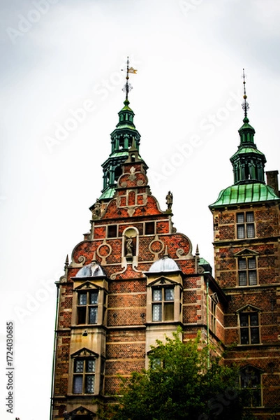Fototapeta Detailed architecture of a historic Danish castle under a cloudy sky in Denmark