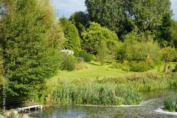 Obraz Tranquil Lake Scene with Lush Green Foliage and Wooden Jetty at Clumber Park, Nottinghamshire, England