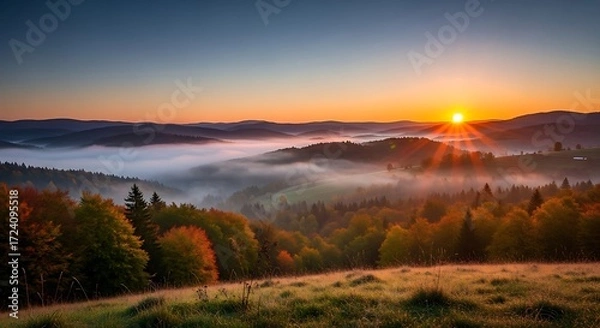 Obraz Sunrise Over Rolling Hills Forest with Mist in Vibrant Autumn Colors