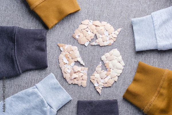 Fototapeta Recycled clothing and sustainable fashion concept with autumn woolen sweater sleeves. Eco-friendly textile reuse, reducing waste, and promoting ecological lifestyle. top view