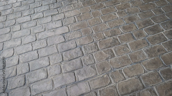 Fototapeta Concrete walkway texture background with alternating brick pattern design, symbolizing structure, durability, organization, and aesthetic detail in urban architecture.