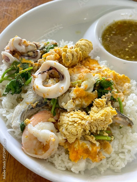 Fototapeta "Dried Rice Porridge seafood " Serve in a cup of cooked rice topped with cooked fish, shrimp and squid.