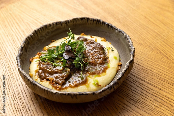 Fototapeta Tender Wagyu beef cheeks with a creamy truffle sauce and mashed potato