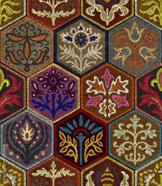 Fototapeta Colorful seamless pattern imitating embroidery. Hexagonal layout with floral folk ornaments. Decorative stitched texture. Vector illustration.