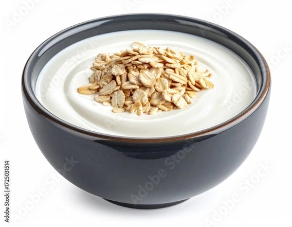Obraz Creamy yogurt topped with a mound of dry rolled oats in a dark gray bowl, isolated on white