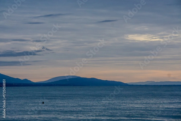 Fototapeta The sky is a beautiful shade of blue with a few clouds scattered throughout