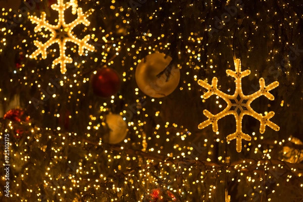 Fototapeta Glowing decorative snowflake in close up, used as a Christmas background element with festive illumination.
