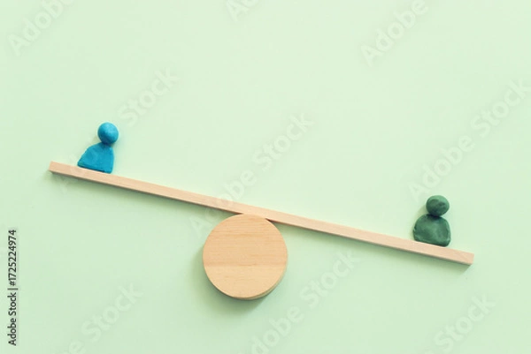 Fototapeta Concept image of figures on wooden scale. Idea of measurement and finding balance
