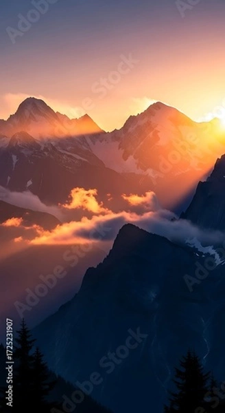 Obraz A breathtaking mountain vista at sunset, showcasing vibrant hues of orange and purple, with dramatic shadows and illuminated peaks.