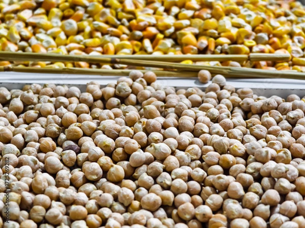Fototapeta Colorful display of peas and corn at a vibrant market stall