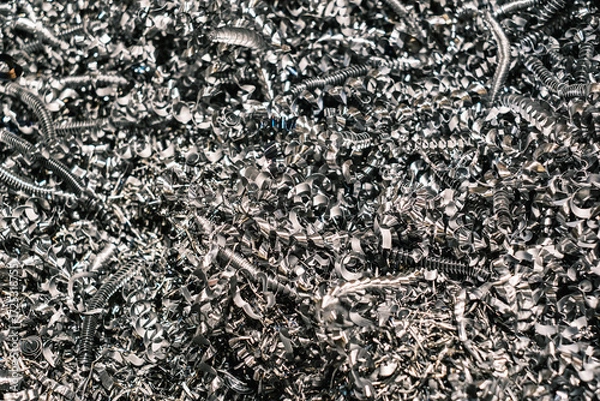 Fototapeta Close-up of metallic shavings and spirals, shiny steel scrap from industrial machining process used for recycling and metal production