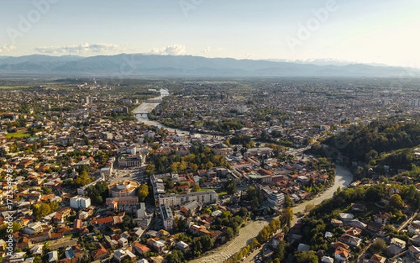 Fototapeta Aerial view of Kutaisi with the Rioni River and Mountains