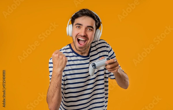 Fototapeta Excited Gamer Man Playing Online Video Game On Console With Gamepad On Yellow