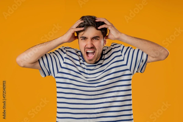Fototapeta Stressed angry man Shouting, Guy In Shock on Yellow. Panicked facial expression
