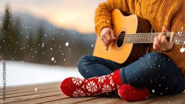 Fototapeta Dreamy visual theme - Cozy Winter Scene: Person Playing Guitar in Snow with Festive Red Socks - surreal emotional atmosphere
