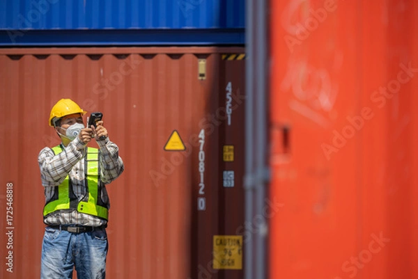 Fototapeta Foreman or worker work at Container cargo site check up goods in container. Foreman or worker checking on shipping containers. Logistics and shipping