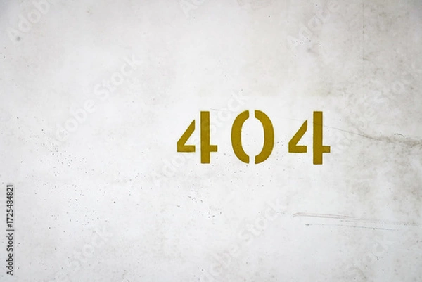 Fototapeta Golden number 404 painted on an old weathered concrete wall, showing metallic house number detail.