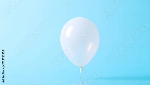 Fototapeta White Balloon Floating Against a Blue Background in Soft Lighting