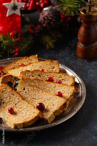 Fototapeta Delicious chicken and pork pate in Christmas decoration. Rustic style. Dark background, metal plates. Front view.