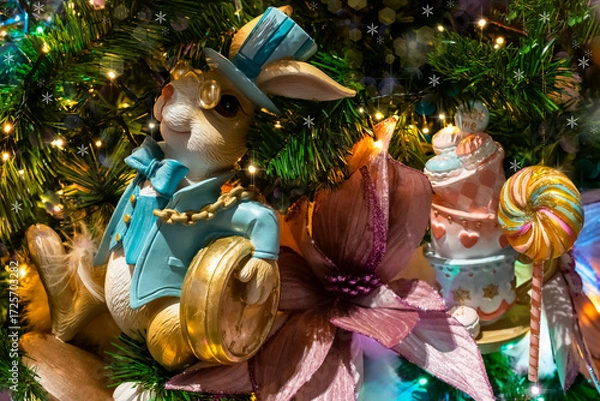 Fototapeta Christmas tree with a Wonderland bunny and marshmallow candy decorations, selective focus. Christmas cute decoration for a children's party