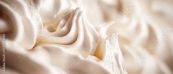 Fototapeta Whipped cream forming creamy, soft-textured surface with golden-hued warmth