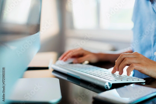 Fototapeta Person typing on a keyboard
