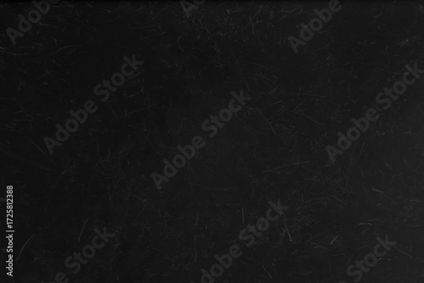 Fototapeta Abstract black grunge background with a scratched and distressed surface, ideal as a dark texture or overlay.