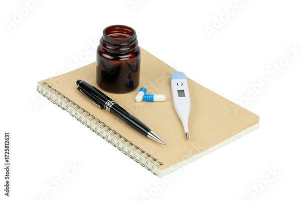 Fototapeta Medical concept with digital thermometer, blue and white medicine pills, and a notebook with a pen, isolated on white background with clipping path.