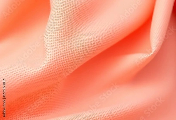 Fototapeta Close-up of vibrant peach-colored fabric, textured surface, top view, knit