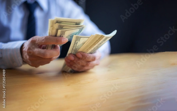 Obraz Business Hands money pocket and counting money American dollars, Office workers receive salary or bonus from executive or boss. loan and finance concep
