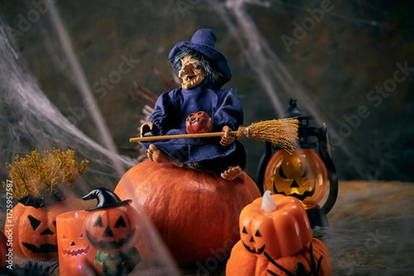 Fototapeta pumpkin halloween party in a cobweb forest where a witch sits on a pumpkin, and fun is happening nearby, All Saints Day, horizontal, creative focus