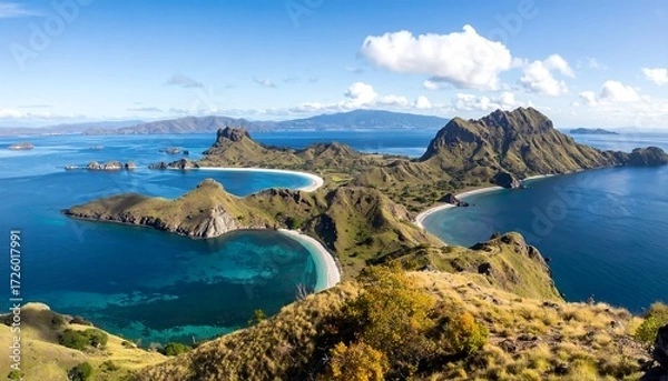 Fototapeta Idyllic island landscape with azure waters and rugged hills under a bright, sunny sky