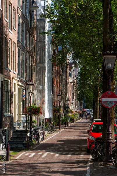 Obraz Charming Amsterdam Street With Vibrant Trees and Parked Bicycles