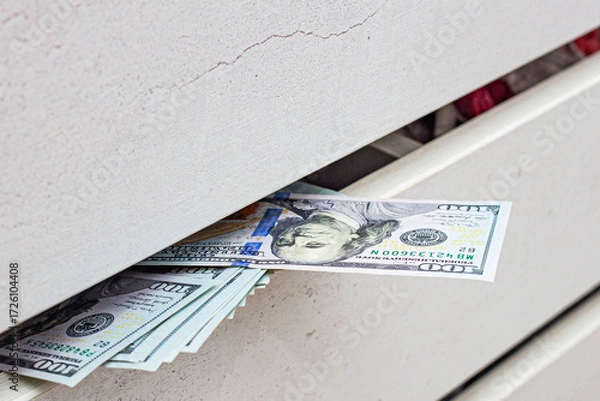 Fototapeta a stash of cash in a closet with underwear kept at home for emergencies