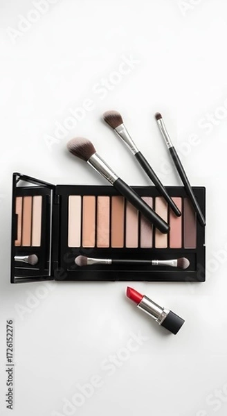 Fototapeta Flat lay: makeup palette, brushes, lipstick, minimalist style, clean white background, soft lighting.