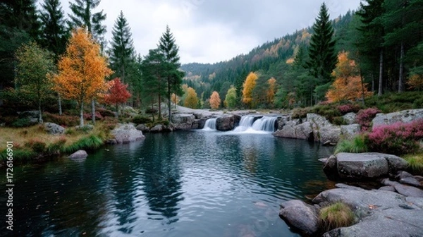 Fototapeta Scenic Waterfall in Autumn Forest with Yellow and Red Trees Reflected in Water Cinematic HDR Landscape