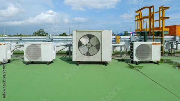Fototapeta Window-type air conditioner outdoor condenser unit installed on a building rooftop,