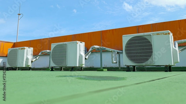 Fototapeta Window-type air conditioner outdoor condenser unit installed on a building rooftop,