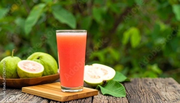 Fototapeta Refreshing pink guava juice in glass, served with fresh guava fruits